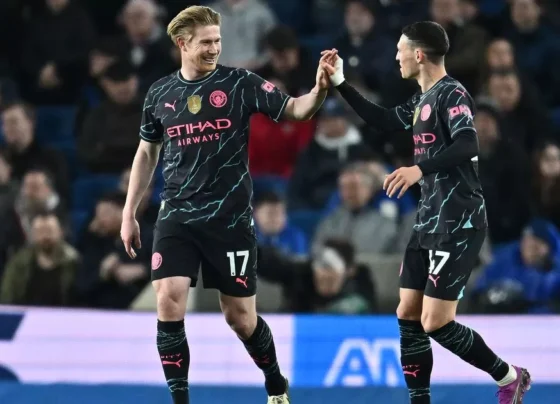 Kevin De Bruyne and Phil Foden celebrating a goal on the football pitch against Brighton.