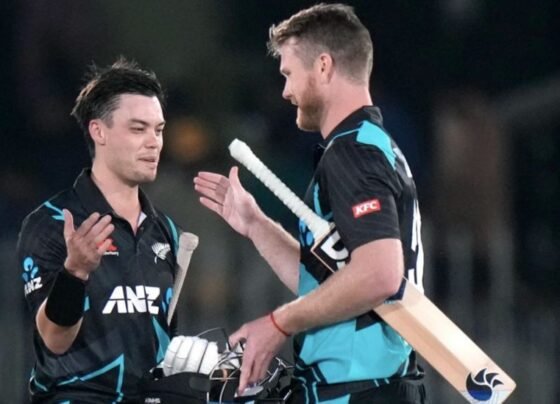 Mark Chapman and Jimmy Neesham in action during a cricket match against Pakistan, seen celebrating on the field.