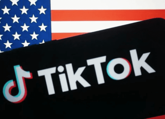 TikTok logo in front of the United States flag