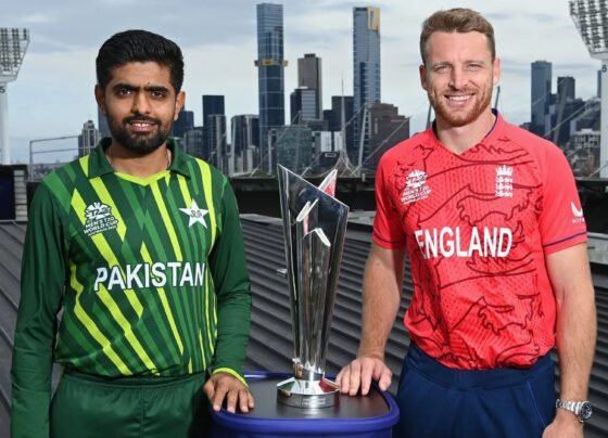 Pakistan and England Cricket Team captains posing next to a trophy